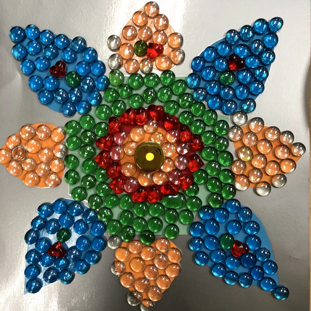 A rangoli made of flat glass marbles as part of our Diwali celebration.